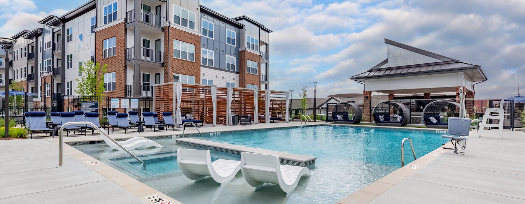outdoor swimming pool with a tanning shelf at Bainbridge Market Commons in Frederick, MD