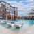 Large sparkling blue pool with a large pool deck and lounge chairs at Bainbridge Market Commons in Frederick, MD