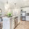 modern apartment kitchen featuring white cabinets and stainless steel appliances